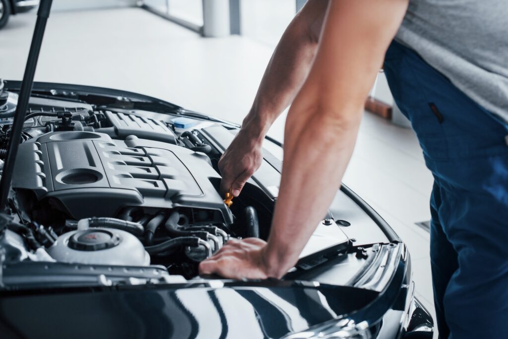 Auto mechanic working in garage. Repair service